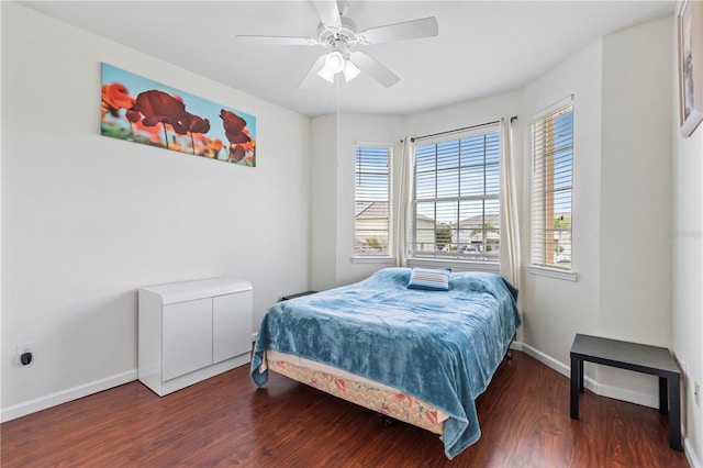 bedroom featuring multiple windows, hardwood / wood-style floors, and ceiling fan