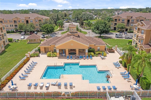 view of swimming pool featuring a patio and a yard