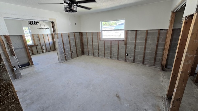 spare room with ceiling fan, concrete floors, and visible vents