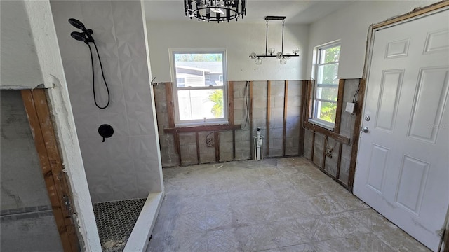 interior space with a notable chandelier and tile walls