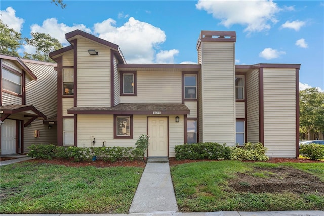 view of property featuring a front lawn