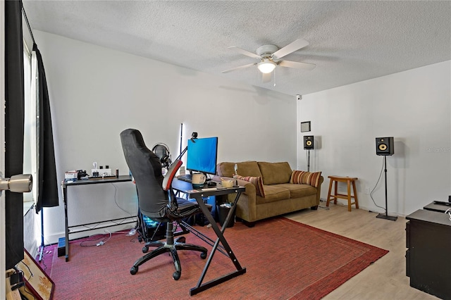 office featuring ceiling fan, a textured ceiling, and light hardwood / wood-style flooring