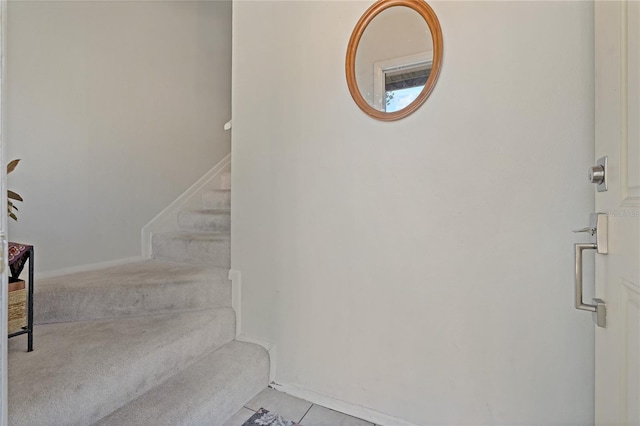 stairway with tile patterned flooring