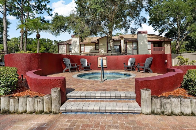 view of pool featuring a patio area and an in ground hot tub