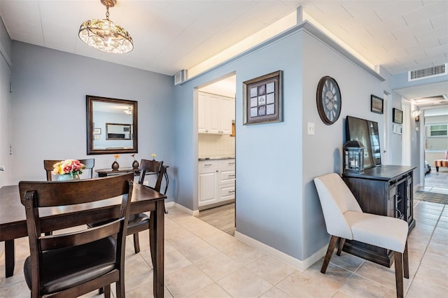 dining area with a notable chandelier and light tile patterned floors