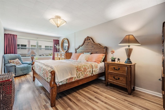 bedroom with light hardwood / wood-style floors