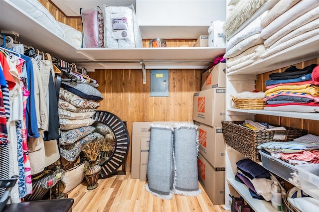 walk in closet with wood-type flooring and electric panel