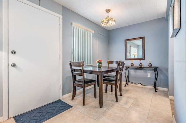 tiled dining room featuring a notable chandelier