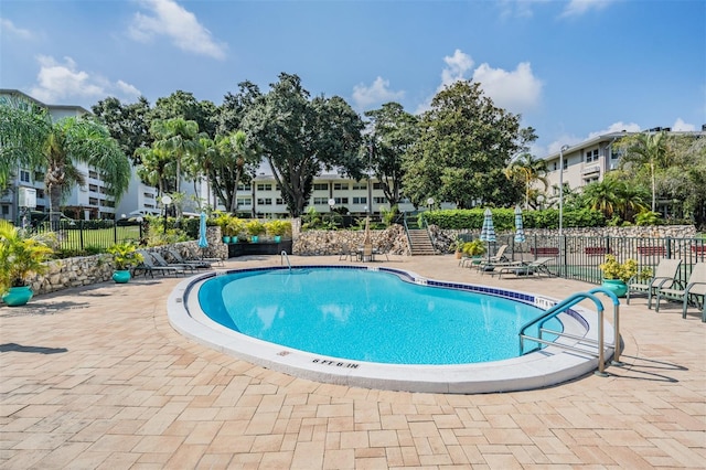 view of swimming pool featuring a patio area