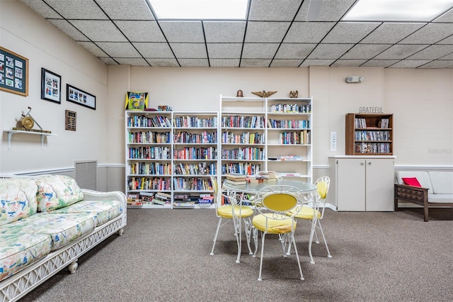 interior space featuring carpet floors and a paneled ceiling