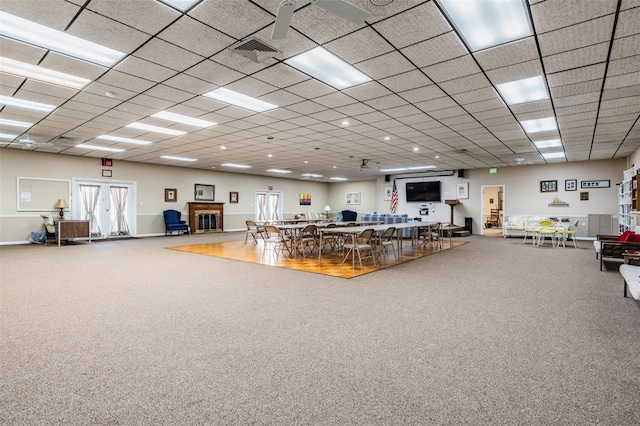 misc room with carpet floors and a paneled ceiling