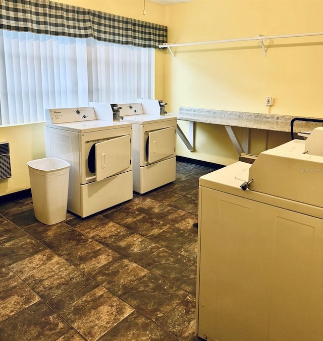 laundry area with dark tile patterned flooring and separate washer and dryer