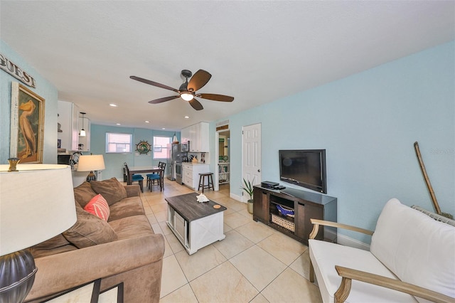 living room featuring light tile patterned floors, a textured ceiling, and ceiling fan