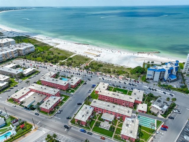 drone / aerial view featuring a water view and a view of the beach