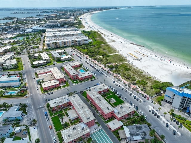 birds eye view of property with a water view and a view of the beach