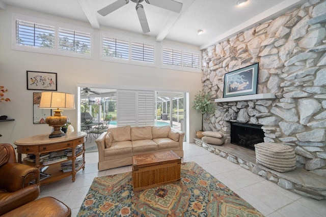 living room featuring ceiling fan, beam ceiling, and light tile patterned flooring