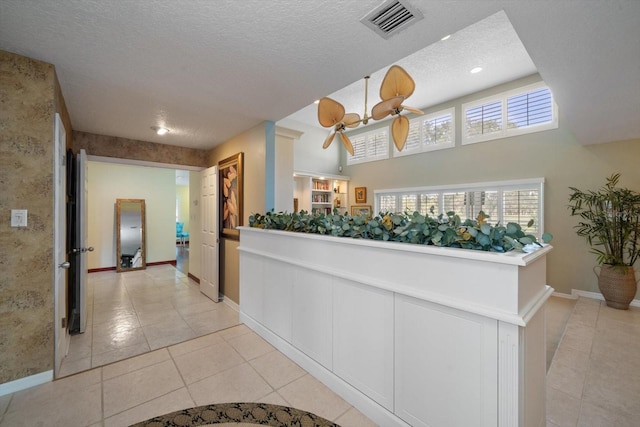 interior space featuring light tile patterned floors and a textured ceiling