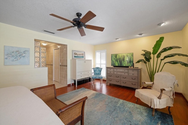 interior space with dark hardwood / wood-style flooring, a textured ceiling, and ceiling fan