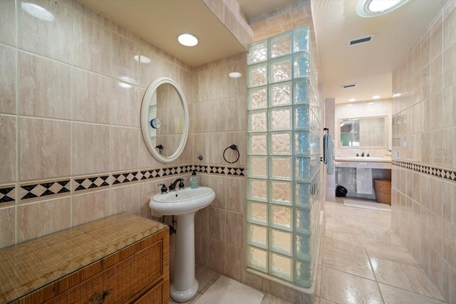 bathroom featuring tile patterned flooring and tile walls