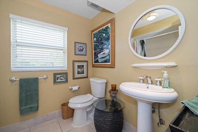 bathroom featuring toilet and tile patterned floors