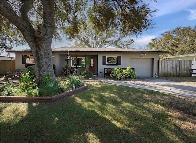 ranch-style home featuring a garage and a front lawn