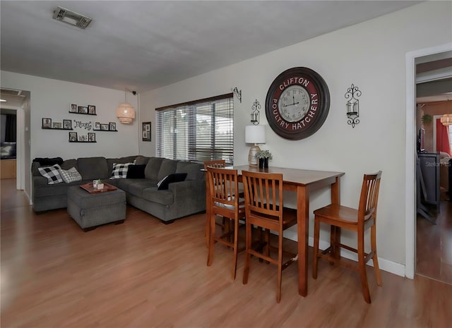 dining space with light hardwood / wood-style flooring