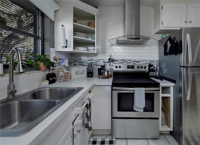 kitchen with white cabinetry, appliances with stainless steel finishes, light tile patterned floors, and wall chimney range hood