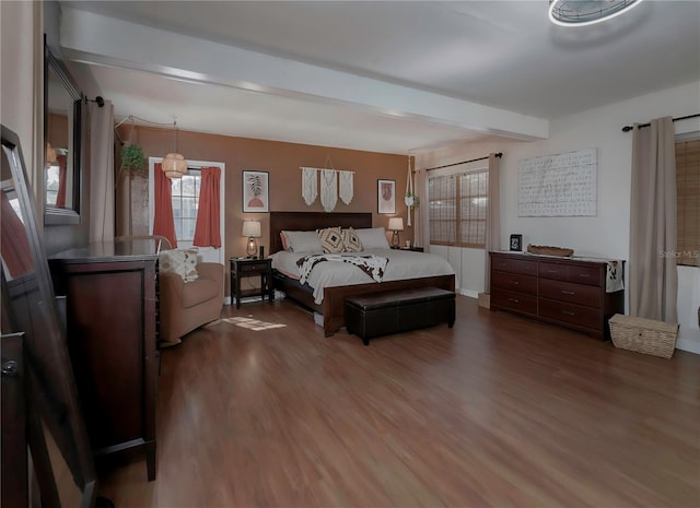 bedroom featuring hardwood / wood-style floors and beam ceiling