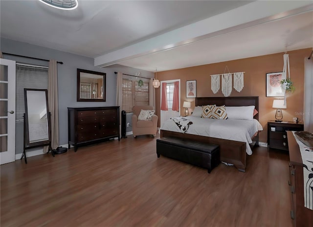 bedroom featuring dark wood-type flooring and beam ceiling