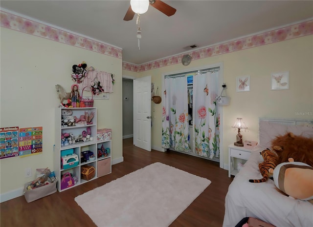 bedroom with ceiling fan and dark hardwood / wood-style floors