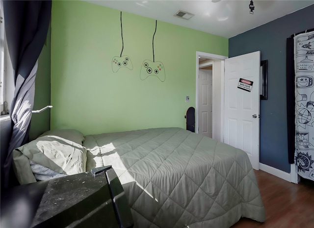 bedroom with hardwood / wood-style flooring