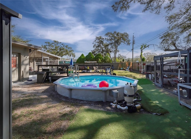 view of pool featuring a lawn