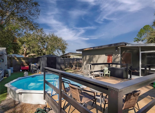 view of swimming pool with a patio area and a shed