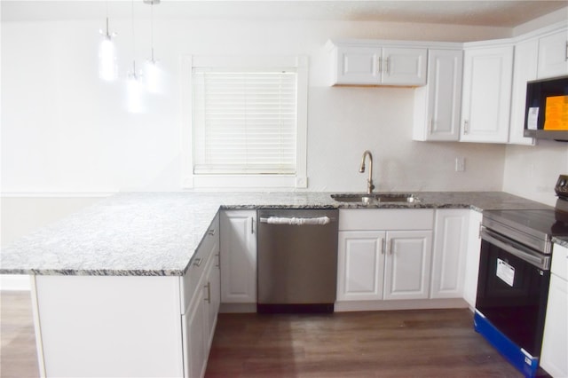 kitchen with stainless steel dishwasher, kitchen peninsula, and electric range oven