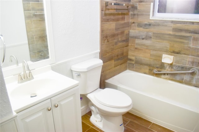 full bathroom featuring tile patterned floors, vanity, tiled shower / bath combo, and toilet