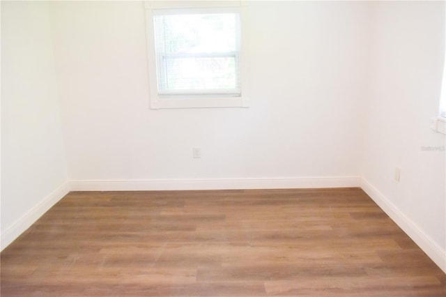 spare room featuring wood-type flooring