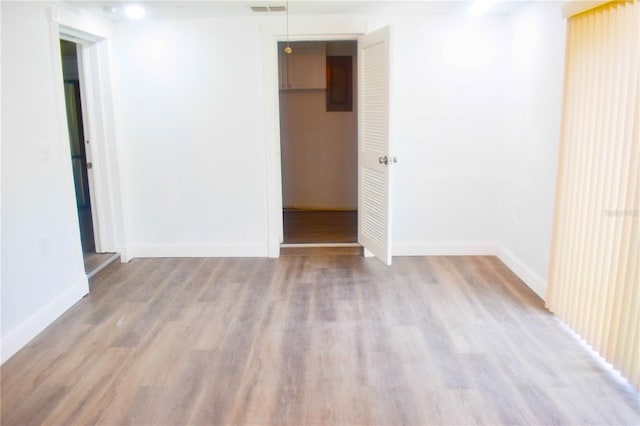 unfurnished room with hardwood / wood-style flooring