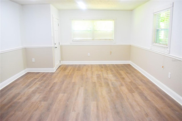 spare room with hardwood / wood-style flooring