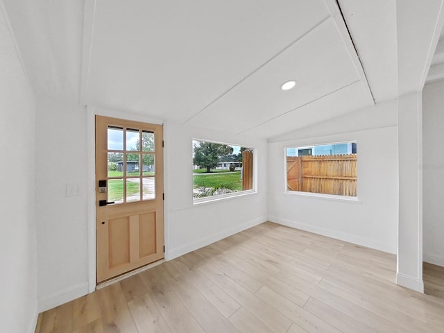 entryway with vaulted ceiling and light wood-type flooring