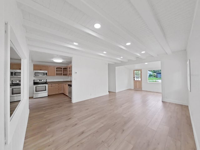 unfurnished living room featuring beamed ceiling and light hardwood / wood-style flooring