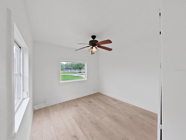 empty room with ceiling fan and light hardwood / wood-style floors