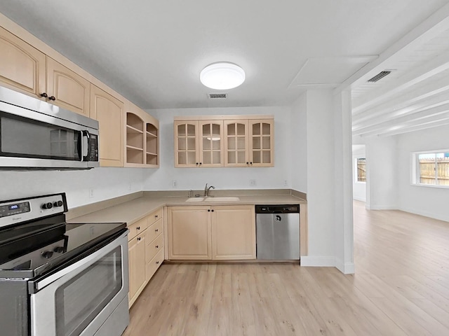 kitchen featuring light hardwood / wood-style floors, appliances with stainless steel finishes, sink, and light brown cabinetry