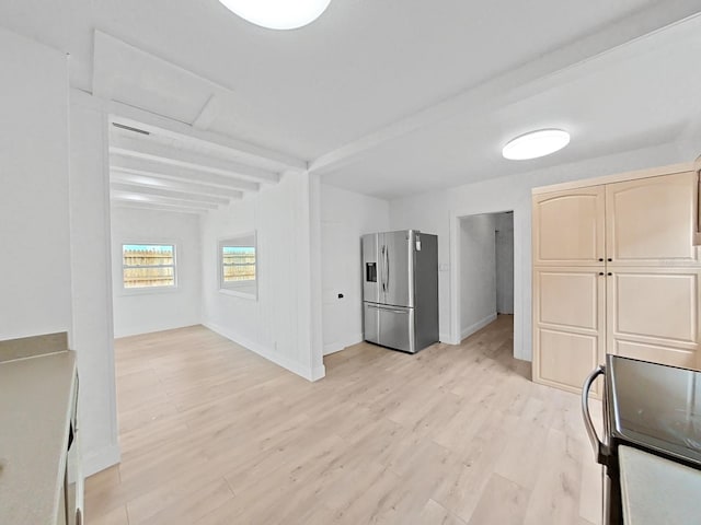 unfurnished living room with beam ceiling and light hardwood / wood-style floors