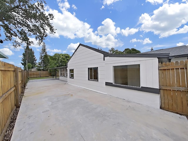 view of side of home with a patio area