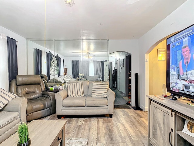 living room featuring ceiling fan and light wood-type flooring