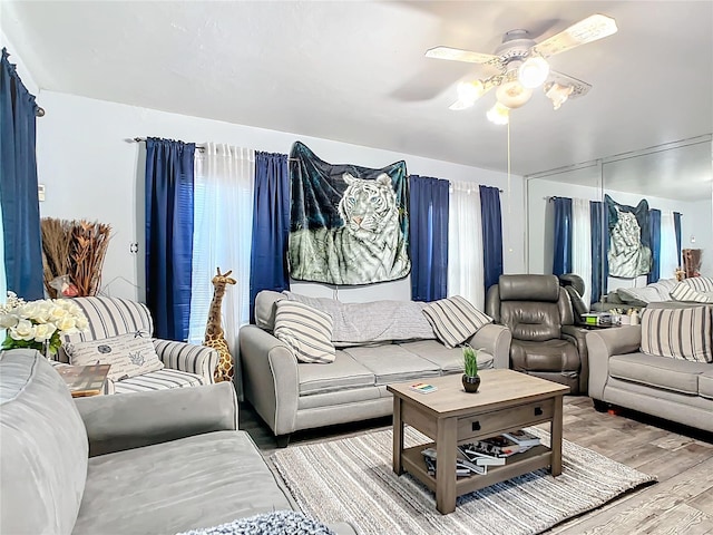 living room with ceiling fan and light hardwood / wood-style floors