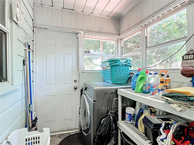 laundry area featuring washer and dryer and wooden walls