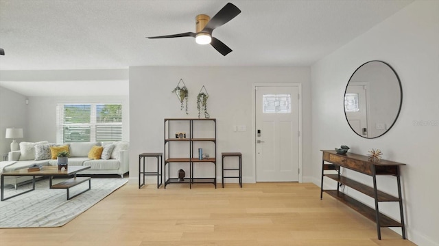 foyer featuring ceiling fan, a textured ceiling, and light hardwood / wood-style flooring