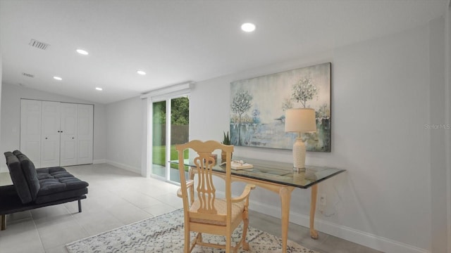 home office with tile patterned floors and lofted ceiling