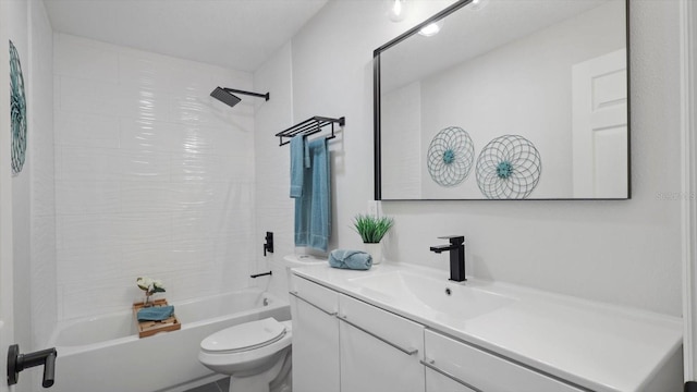 full bathroom featuring toilet, tiled shower / bath, and vanity